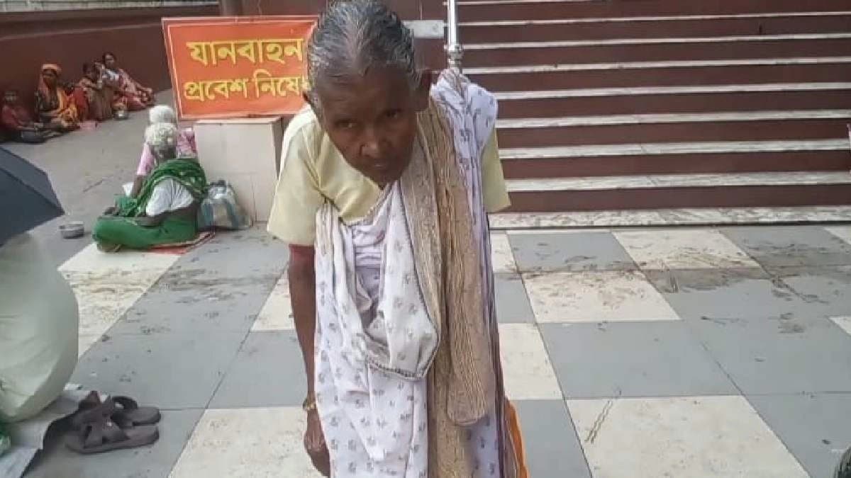 Hapless elderly mother begging outside of temple to treat her ailing son
