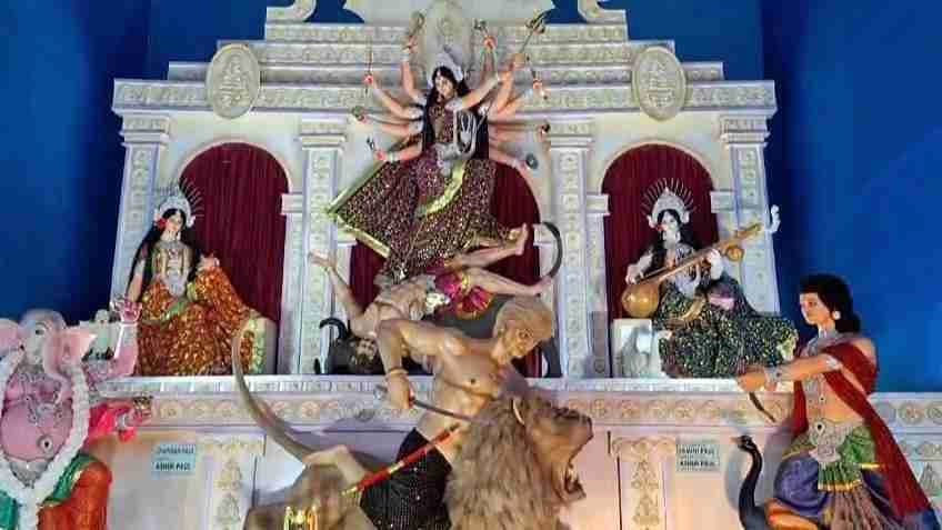 People are thronging at a  Durga Puja pandle to see Mahishasura as Donald Trump