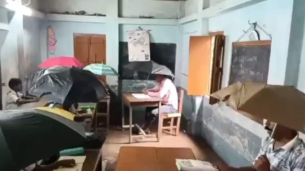 Teachers and Students Use Umbrellas amid Rainwater Leaks Through Tin Roof in Pandua School