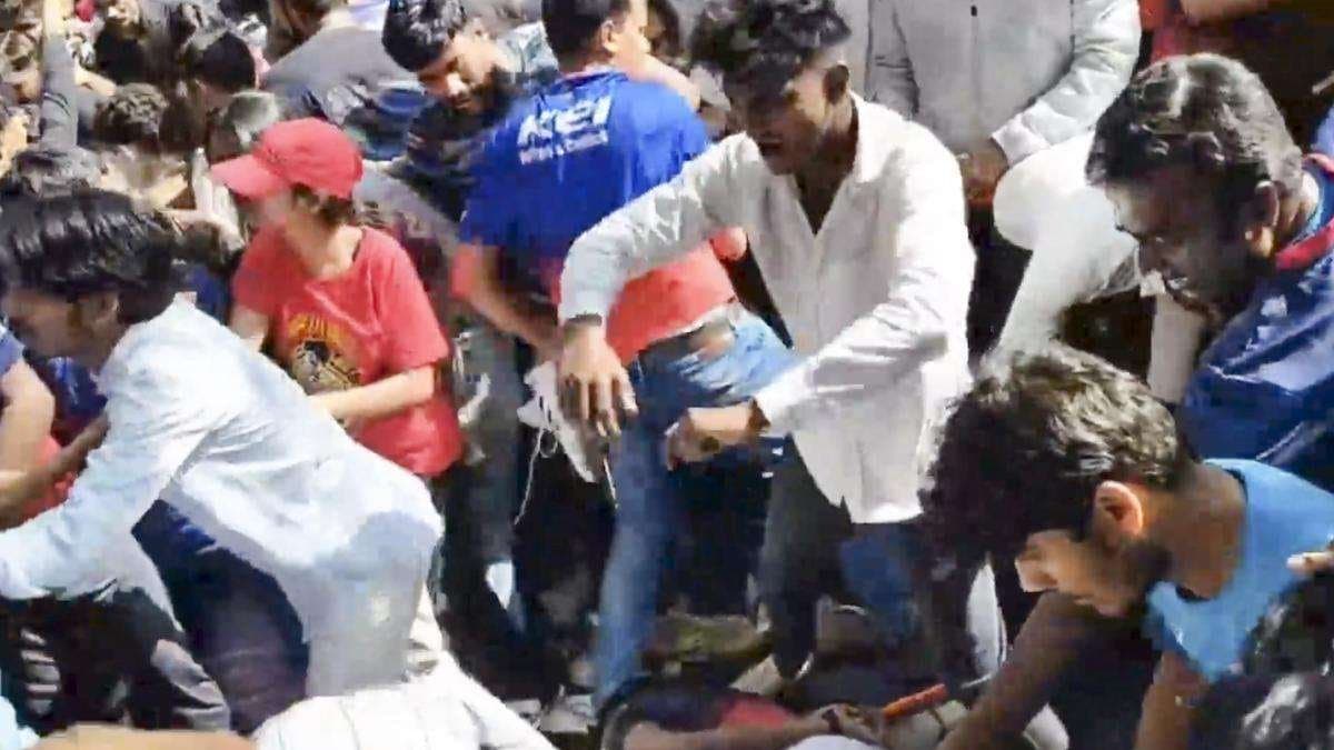Father Holds On To Grave Of Son Killed In Stampede
