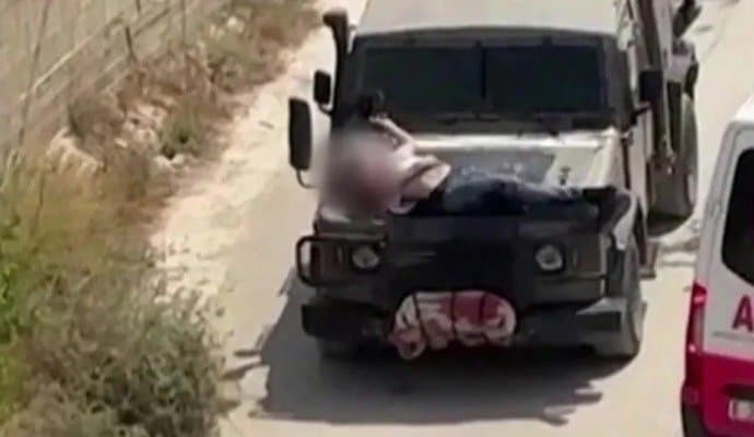 Israeli soldiers driving with injured Palestinian strapped to a jeep
