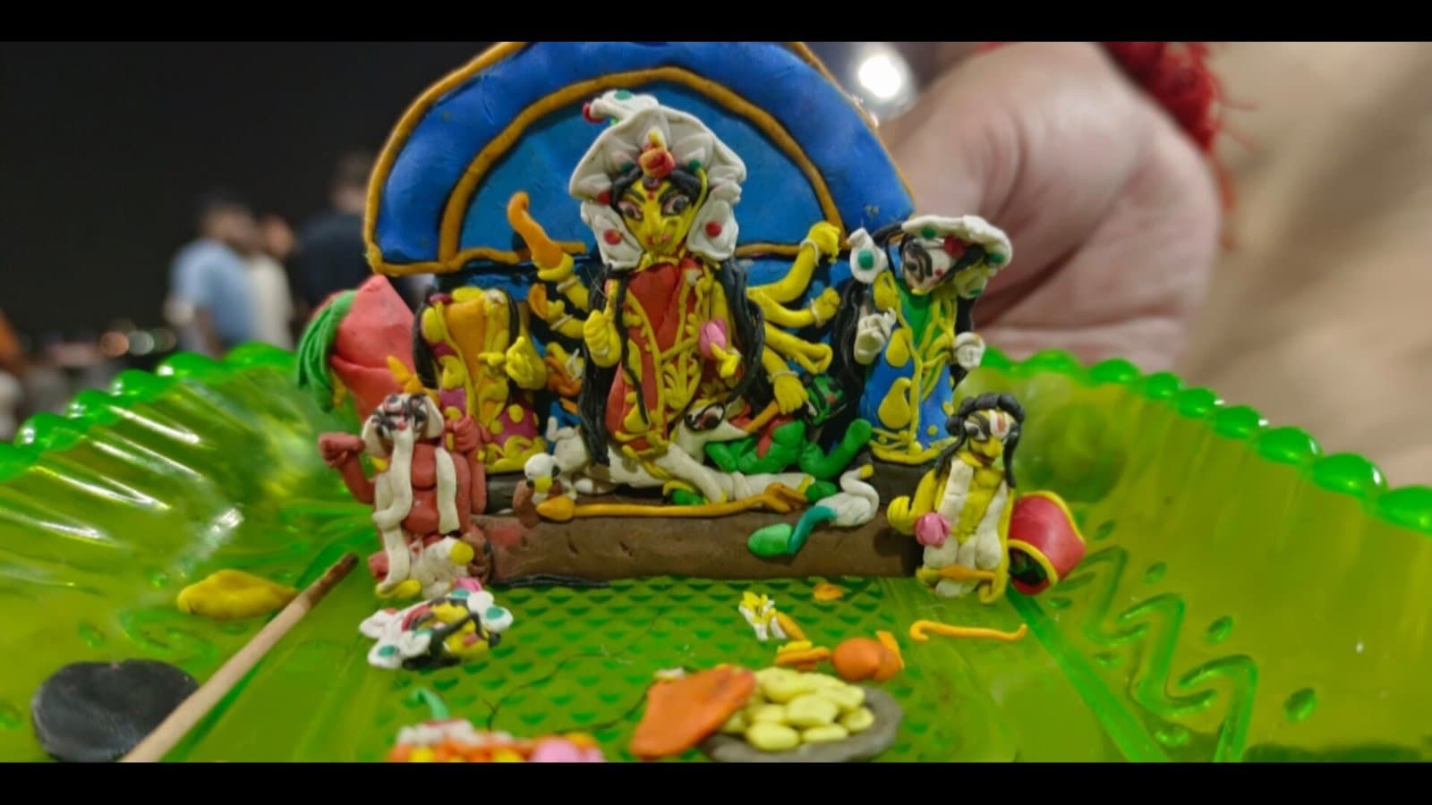 one-and-a-half-inch Durga idol, made by a Kasba boy, was immersed alongside the local Puja committee's idol_gnr