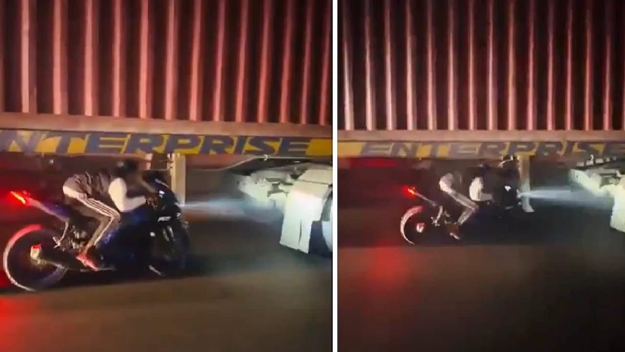 Biker preform deadly stunt beside speeding truck tyres to make reels