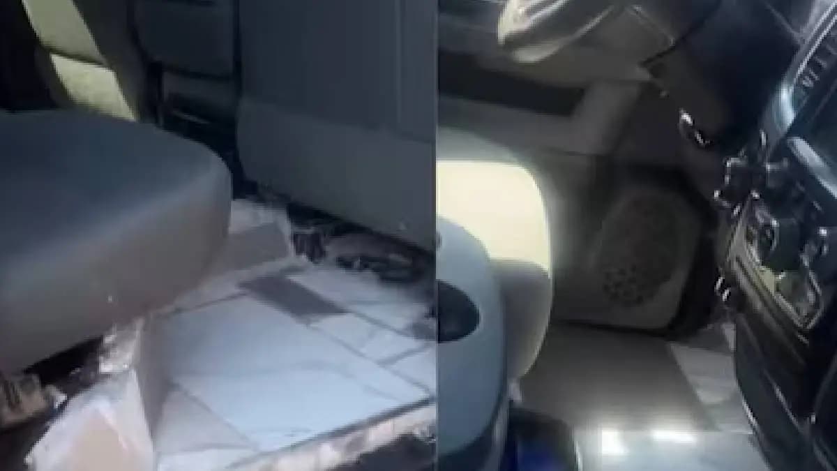 Young man installs tiles in car