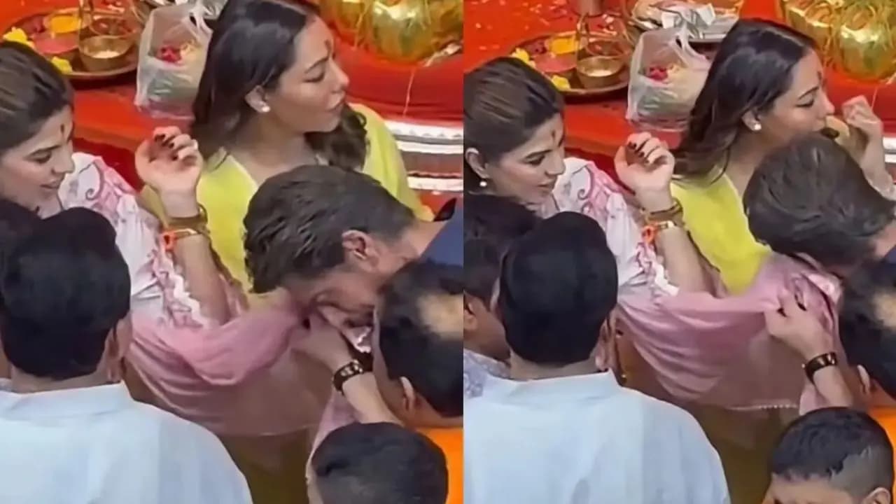 Shah Rukh Khan wipes face in pooja dadlanis dupatta during his visit to Lalbaugcha Raja with full family