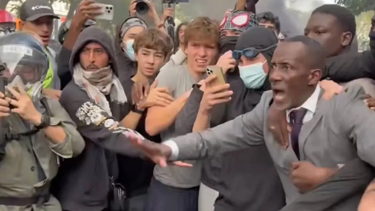 In the battlefield of Paris the mayor stood defiantly chest bared facing police batons
