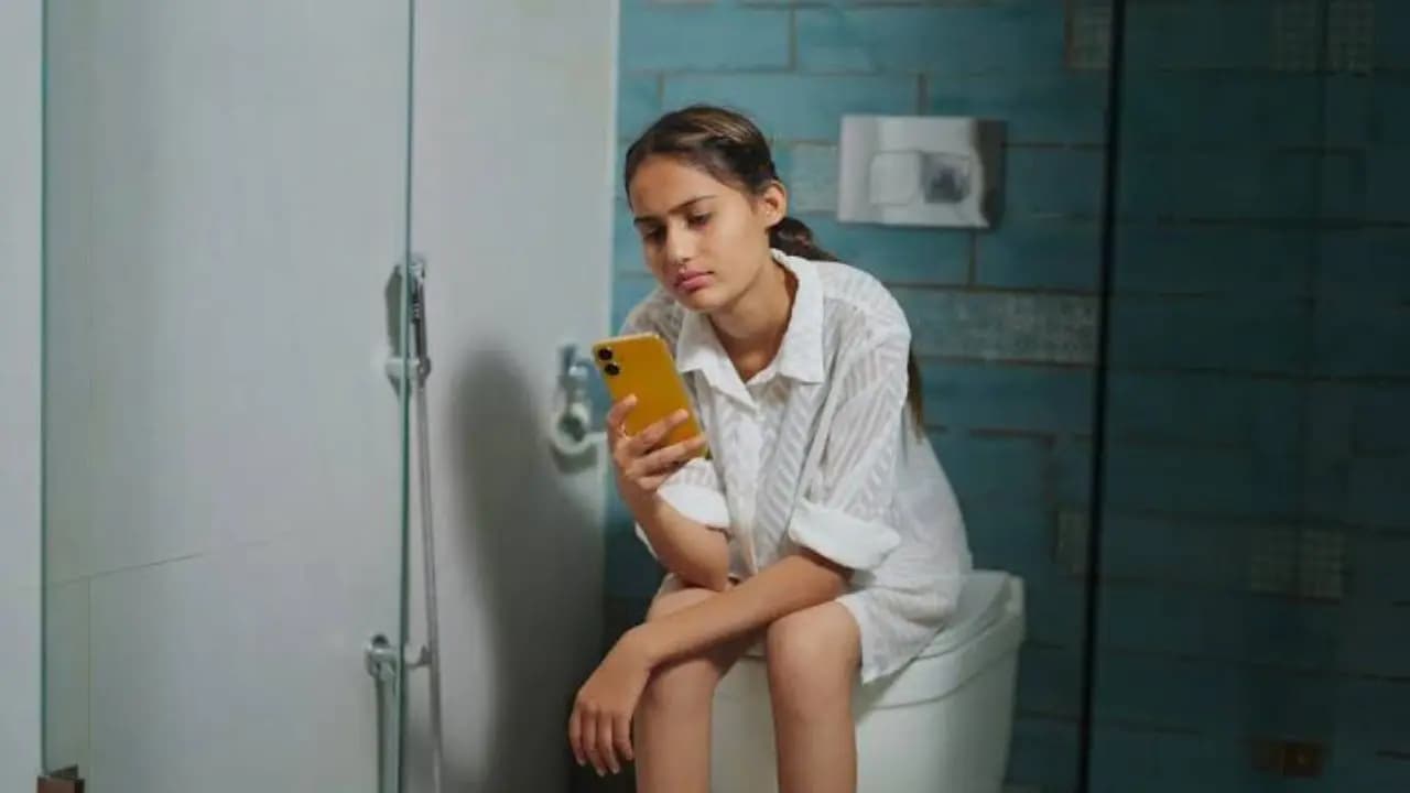 toilet scrolling: dont sit on toilet too long doctor warns